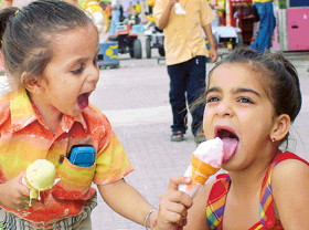 I want yours too: A boy seems to be asking his sister for her ice cream in Ludhiana on Thursday.
