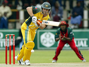 Australian batsman Adam Gilchrist drives a delivery during his 20-run innings before being dismissed off Douglas Hondo during the second one-day international at the Harare Sports Club on Thursday. 