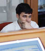 A nervous stockbroker monitors a screen as share prices crashed in Mumbai on Friday with the benchmark Sensex diving over four per cent in the afternoon trade.