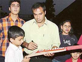 Former Test player Robin Singh gives autographs to children during his visit to St Stephens School, Sector 45, Chandigarh, on Friday. 