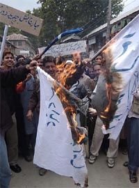 Kashmiri protesters hold a burning flag of Israel during a demonstration after the Friday prayers in Budgam, 25 km north of Srinagar.