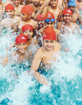Children have fun in a swimming pool to beat the heat in Ludhiana on Saturday. 