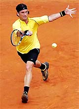 Carlos Moya of Spain hits a forehand to Raemon Sluiter of the Netherlands during their third-round match at the French Open 