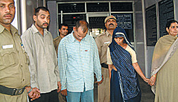 Constable Ravinder Kumar (centre), his brother Pushpender Kumar and mother Phoolwati, who have been arrested for the murder of the constables wife.