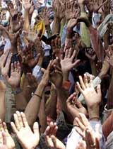 Farmers raise their hands during a kisan rally at the AICC headquarters in New Delhi 