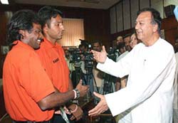 Union Sports Minister Sunil Dutt having a word with members of the Indian hockey team which left for the USA on Tuesday to participate in a 21-day training programme. 