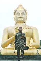 A Thai marine guards a Buddhist temple in Muslim dominant Narathiwat province, 750 miles south of Bangkok 