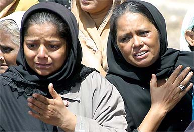 Relatives of bomb blast victims mourn during funerals in Karachi on Tuesday