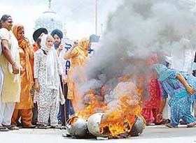 Members of the Kalgidhar Sevak Jatha burn helmets outside the Amb Sahib Gurdwara, Phase VIII, in Mohali