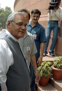 Former Prime Minister Atal Bihari Vajpayee smiles as he enters Parliament House in New Delhi on Wednesday. 