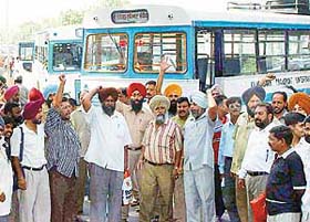 The CTU Workers Joint Action Committee holds chakka jam at the Sector 17 ISBT in support of their demands in Chandigarh