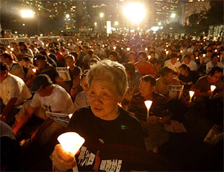 People participate in a candlelight vigil to mark the 15th anniversary of Chinas Tiananmen Square crackdown on Friday. 