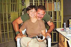 Charles A. Graner seen  with Lynndie R. England in Abu Ghraib prison. England has been accused of assaulting the jail inmates and conspiring to ill-treat them. 