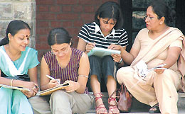 Admission seekers taking help from their parents before submitting their forms at St. Stephens College.