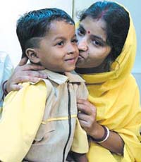 5-year-old Suman Samui with his mother, after he was restored to his parents by the East Delhi Police. 