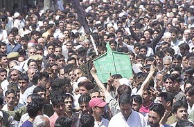 Mourners carry the coffin of Maulvi Mushtaq Ahmad in Srinagar on Tuesday. 
