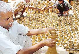 Potter Sadhu Ram is busy making earthen mugs with his family members in Sector 25 Kumhar Colony in Chandigarh on Thursday after Railway Minister Laloo Prasad Yadav banned the use of plastic cups for tea on railway platforms across the country. 