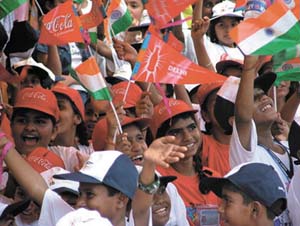 Schoolchildren waving flags during the Olympic Torch Relay in the Capital