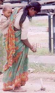 A destitute woman searches for iron scrap on a road in Ludhiana to eke out a living