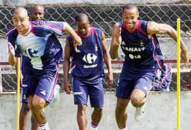 France's David Trezeguet and Thierry Henry  run during a training session in the town of Santo Tirso