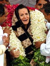 Congress President Sonia Gandhi being garlanded by party workers at a public rally in Lalganj, Uttar Pradesh