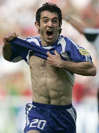 Greeces Giorgos Karagounis celebrates after scoring the first goal of the Euro 2004 soccer championships opening match against Portugal