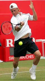 Australias Lleyton Hewitt returns the ball to Russias Igor Andreev in their quarter-final match at the Stella Artois tennis championships at The Queens Club, London