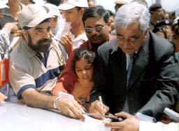 Chief Minister Mufti Mohammad Sayeed gives autograph to tourists