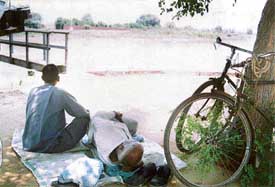 Relatives of missing Kala camp at the South City bridge over the Sidhwan Canal in the hope of recovering the body