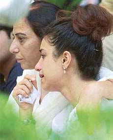 A relative of an Uphaar Cinema tragedy victim breaks down after paying tributes at the memorial in New Delhi