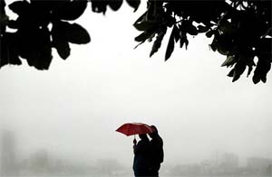 A couple enjoys the first monsoon showers of the season