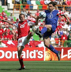 Croatias Tomislav Sokota kicks the ball in front of Switzerlands Patrick Mueller during their Group B Euro 2004 soccer match