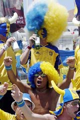Swedish soccer fans sing and drink at the Rossio square