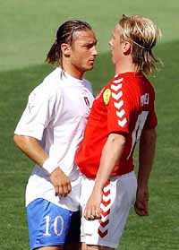 Francesco Totti confronts Christian Poulsen of Denmark during their Group C match 