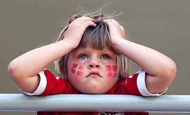 A young Danish supporters waits for the start of the Group C match