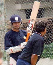 Former Indian captain Kapil Dev gives batting tips to fast bowler Irfan Pathan at the five-day fitness camp for pace bowlers at National Cricket Academy