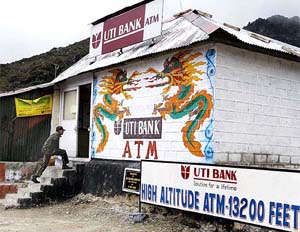 An Indian soldier climbs up the steps to the worlds highest automatic teller machine