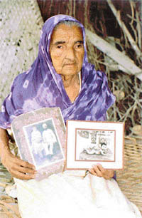 Ms Sarjeet Kaur shows photographs of her late husband and son in Bhaini Arora village