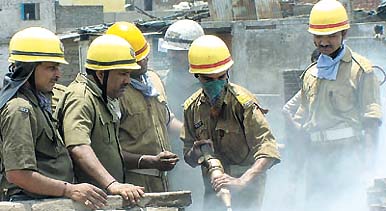 Firepersons trying to douse the flames at the toy market in Sadar Bazar in the Capital on Tuesday