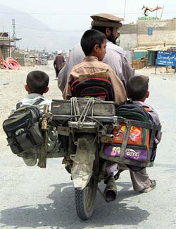 Pakistani tribesman Anwar Khan rides a motorcycle