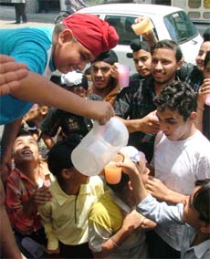 A boy distributes sweetened water on the occasion of martyrdom day of Guru Arjan Dev on Wednesday.