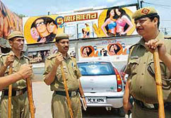 Delhi policemen assigned for the security of a cinema screening Bollywoods latest films "Girlfriend" stand guard in front of its entrance in New Delhi on Wednesday.