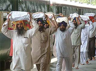 Devotees carry old "birs" of Guru Granth Sahib from gurdwaras in Pakistan