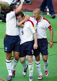 England's Wayne Rooney is congratulated by teammates