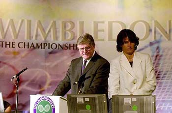 Alan Mills, the Chief Referee for the 2004 Wimbledon tennis tournament, makes the draw for the tournament with Assistant Referee Claire Wood