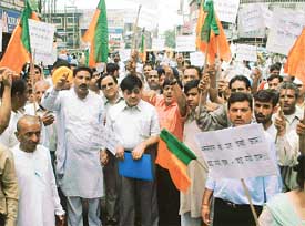 BJP activists hold a demonstration against the hike in the prices of petroleum products and the inclusion of tainted ministers in the Union Cabinet