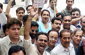 BJP activists stage a demonstration against the inclusion of tainted ministers in the UPA Government in the Centre, in Amritsar on Friday.