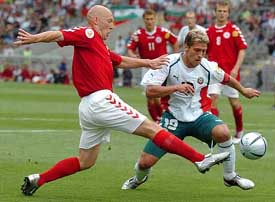 Thomas Gravesen of Denamrk shoots past Stilian Petrov of Bulgaria