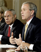 US President George W. Bush speaks next to Secretary of State Colin Powell