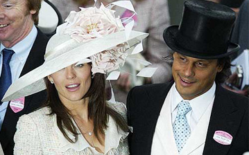 British actress Liz Hurley and companion Arun Nayar pose for the cameras, after she presented a trophy, on the third day of the annual Royal Ascot horse race meeting at Ascot, England, on Thursday.  Thursday is traditionally called 'Ladies Day', where fashionable hats are worn.  Ascort which is attended by Britain's Queen Elizabeth and other members of the royal family, is one of the highlights of the English social season.  